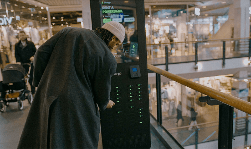 A customer renting a power bank from a Chargo station